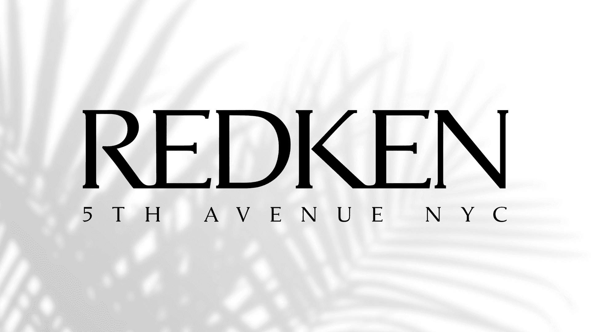 Redken logo with black feather-like design background.